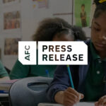 Student sitting at desks in a classroom