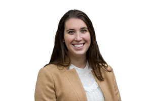 Woman smiling with a tan blazer and white shirt
